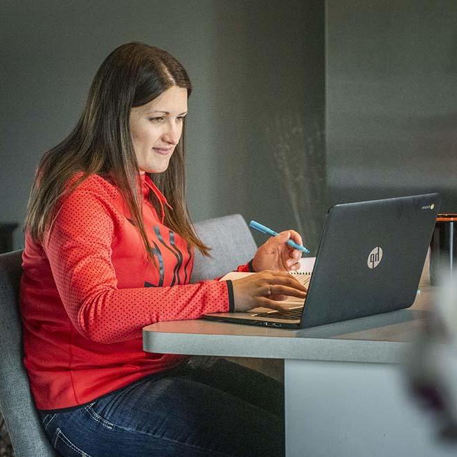 Adult student studying at kitchen counter at home